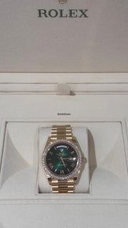 Rolex | Day-Date | 228348RBR | Yellow gold | 40 x 48 mm | Yellow gold | Green | Automatic